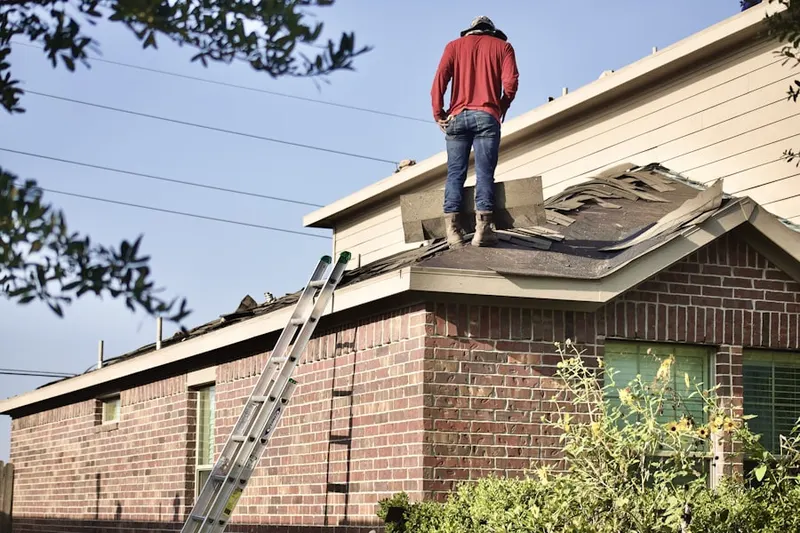 Professional roofer working on a residential roof in Goleta